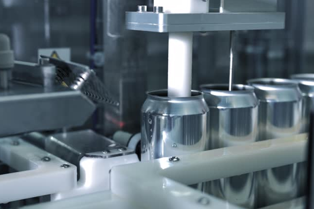 A man working on a machine for printing labels and barcode on boxes in a warehouse.