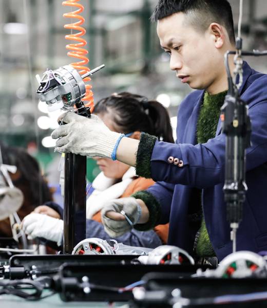 JIUJIANG CHINA-March 17, 2018: workers on the production line of electrical appliances company, Jiujiang, Eastern China. Workers can't relax for a minute, like robots in Chaplin's movie modern times.